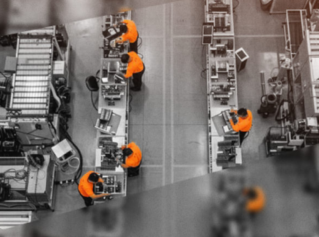 Overhead view of technicians working along a factory assembly line