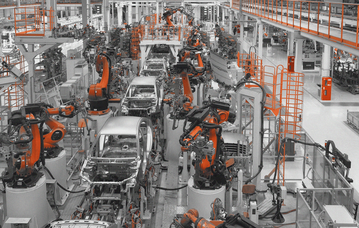 Robotic arms assembling a vehicle body on a production line